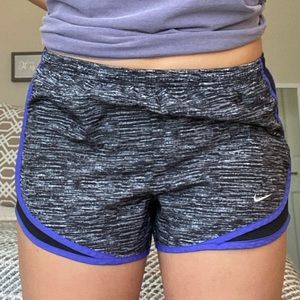 Grey patterned Nike running shorts